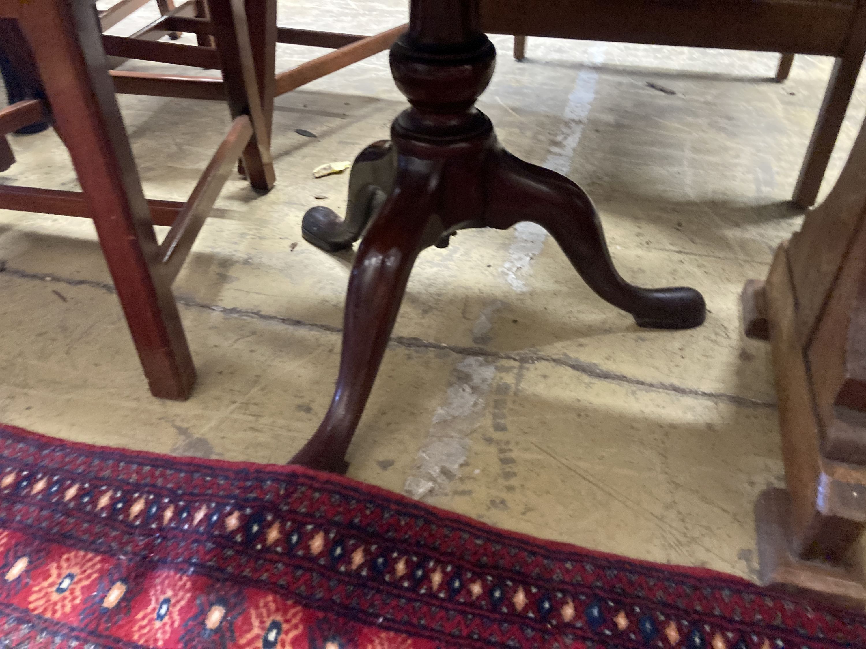 A Georgian mahogany revolving three tier dumb waiter, height 100cm